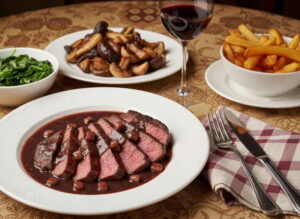 Wine with food: Entrecôte à la Bordelaise steak alongside a glass of Pauillac red wine.