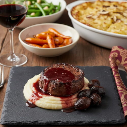 Wine with food: Filet mignon with port shallots on parsnip puree alongside a glass of dark Malbec.