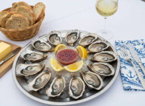 Wine with food: Fresh oysters from Arcachon on ice alongside a glass of Entre-deux-Mers white wine.