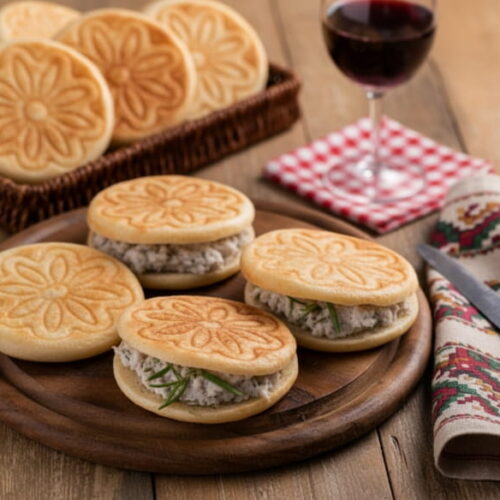 Wine with the meal: Warm tigelle with cunza alongside a glass of Lambrusco red wine.