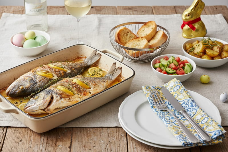 Wine with food: Whole sea bream with lemon and thyme alongside a glass of Albariño wine.